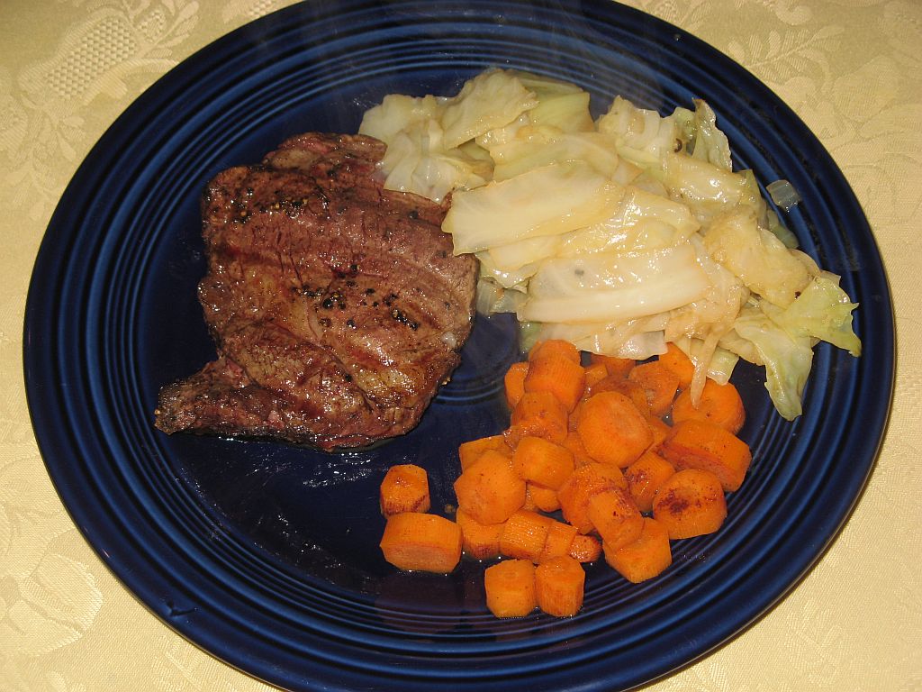 Beef tenderloin steaks, braised cabbage and carrots